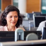 woman sitting in front of desktop