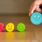 group of blocks sitting in a row with faces on them