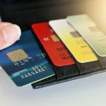 hand holding a stack of credits cards
