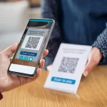 person using a cashless app on their smartphone