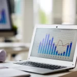 laptop showing bar graphs on the screen